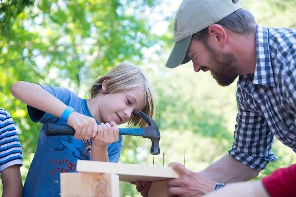 A camper builds a pollinator hotel.