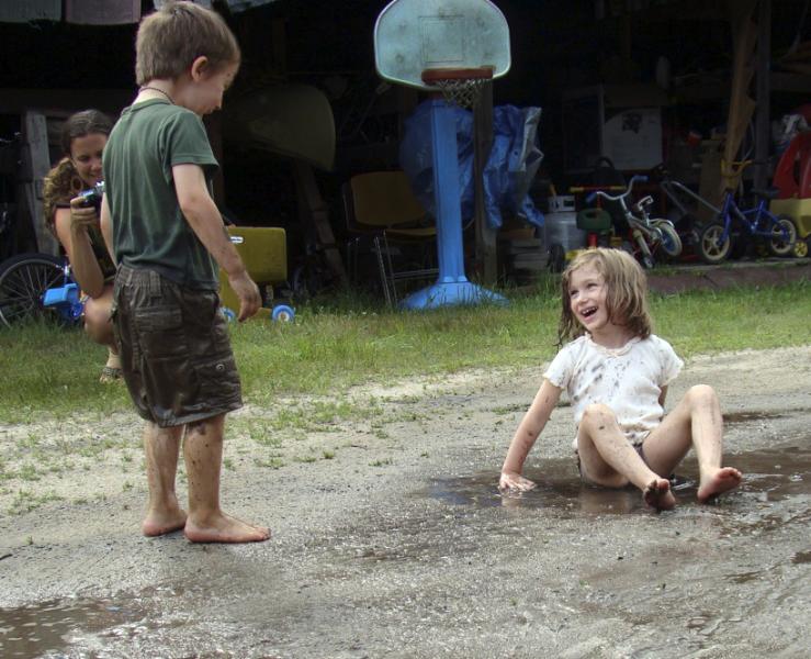 Mud puddles turned out to be a big hit at a birthday party several years ago attended by Piper Kraus-Fabel, left, of Amherst, and River Rodrigues, of Montague. PHOTO COURTESY OF AMY HOWLAND