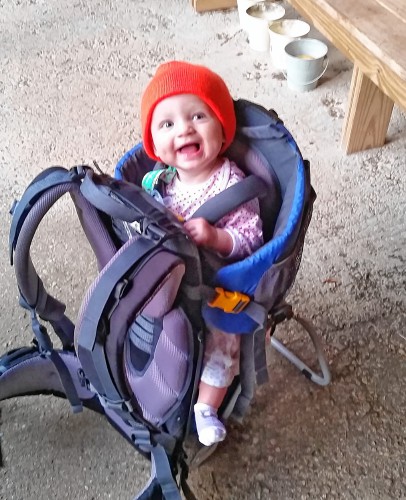 The author's daughter sporting all previously loved clothing and enjoying being in a previously loved backpack. KATIE KOERTEN